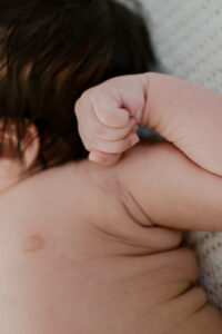 Close shot of a baby's fist as he stretches